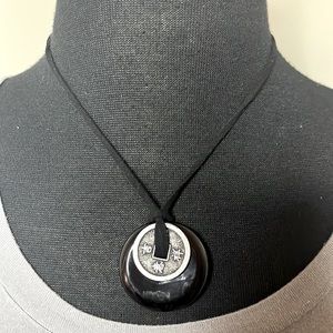 Nwot black circle necklace topped with pewter color with Chinese symbols